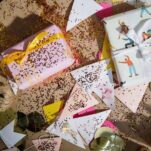 wrapping paper and wrapped package laying around with glitter strewn all over